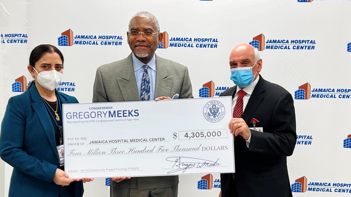 Rep. Gregory Meeks holding check for Jamaica Hospital in NY.