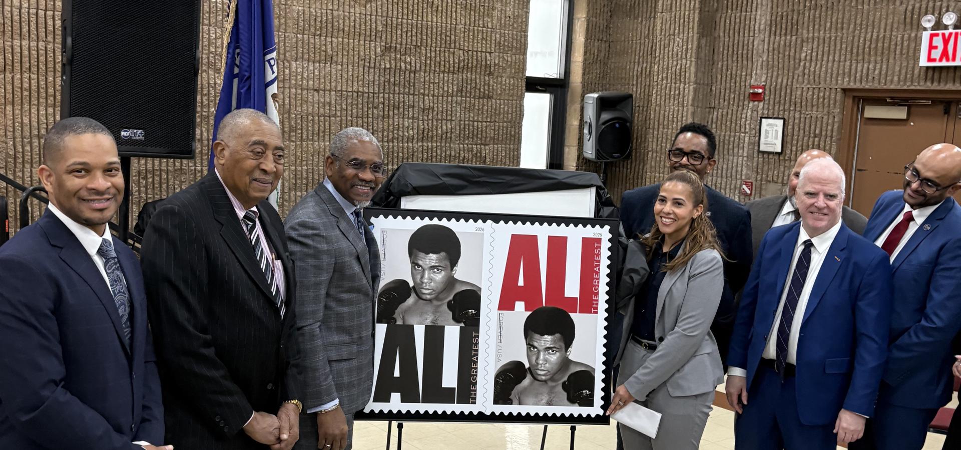 group of people with a stamp honoring Muhammad Ali