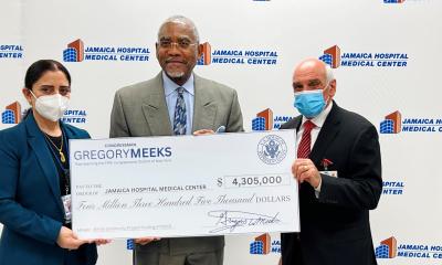 Rep. Gregory Meeks holding check for Jamaica Hospital in NY. 